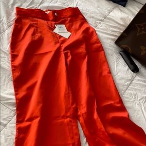 Orange pants with a slit in the leg